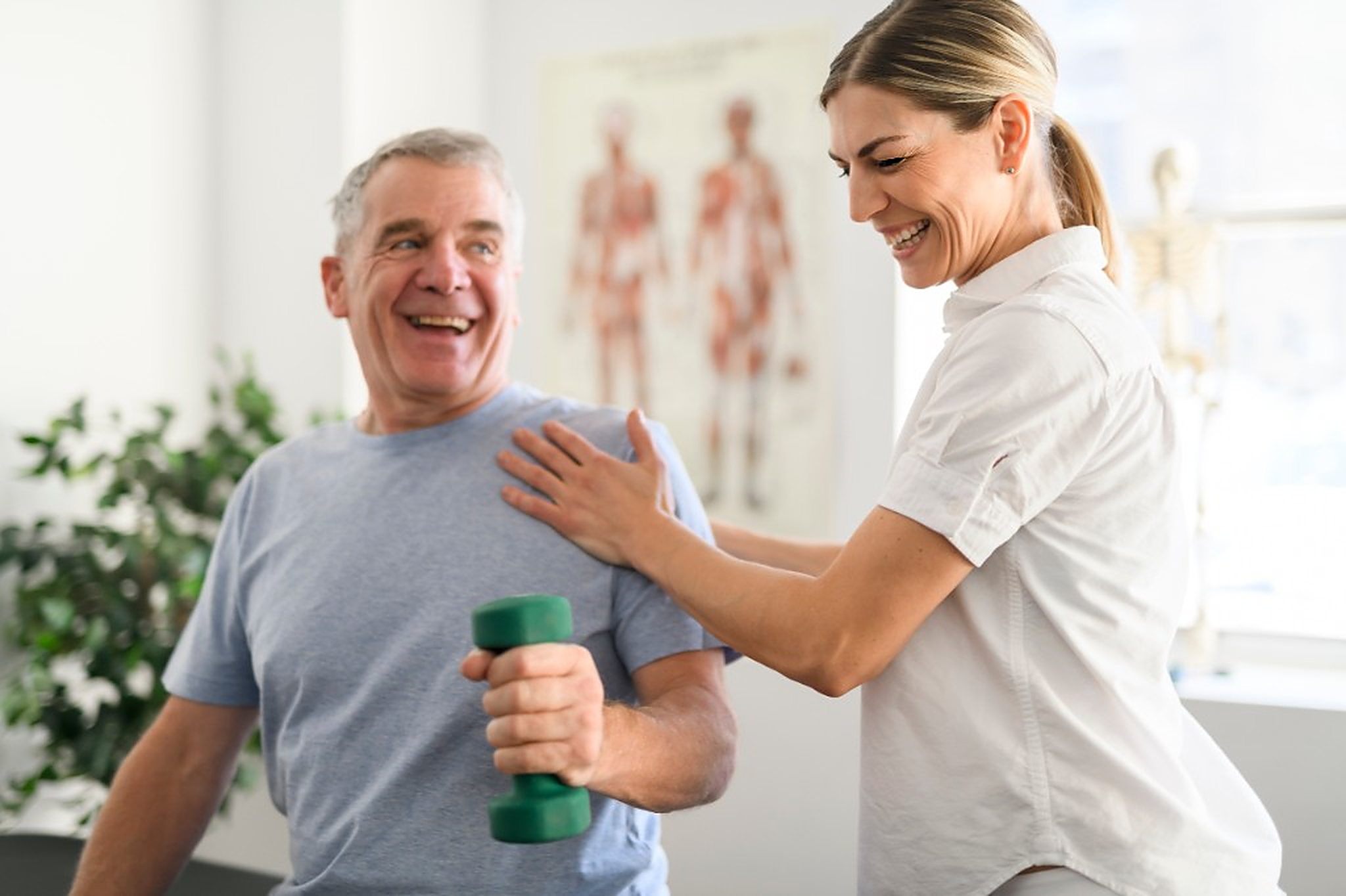Clinician guiding an older patient through a strengthening exercise