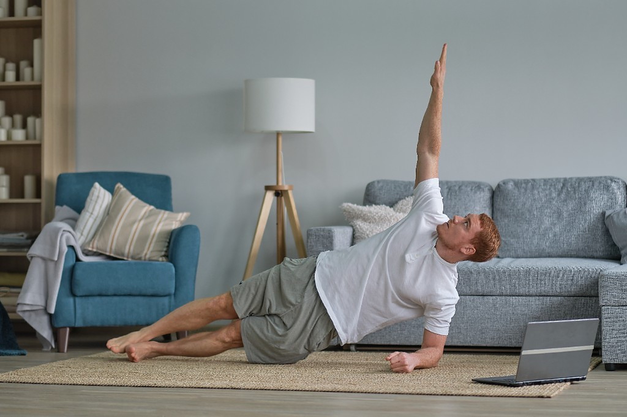 Patient following a home exercise program with a laptop in their living room